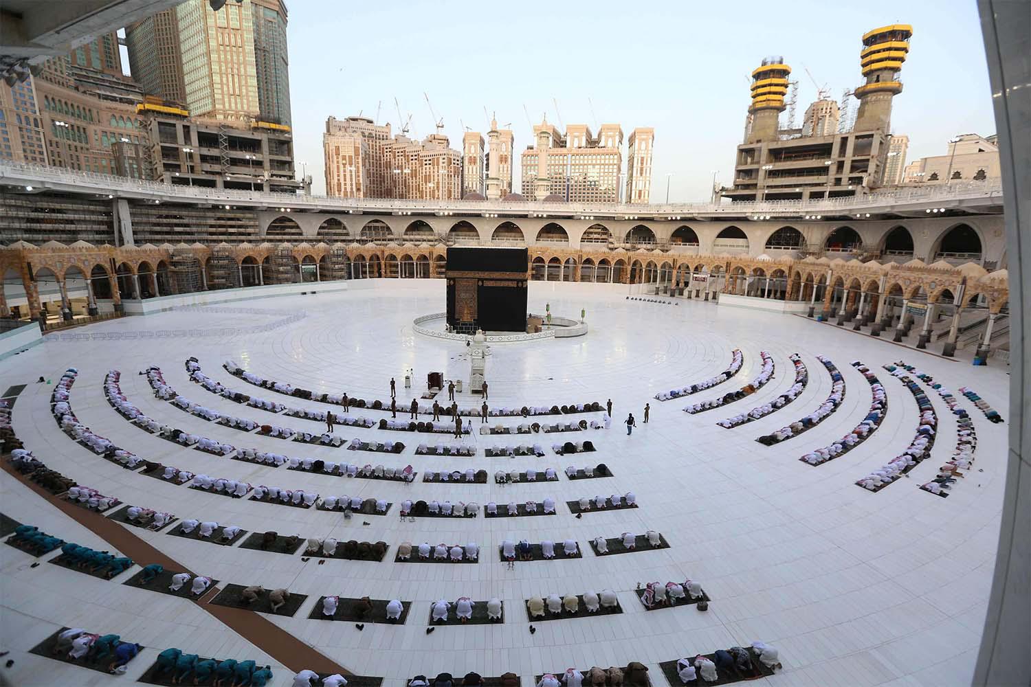 Worshippers gathering before the Kaaba at the Grand Mosque in Saudi Arabia's holy city of Mecca to attend the prayers of Eid al-Fitr