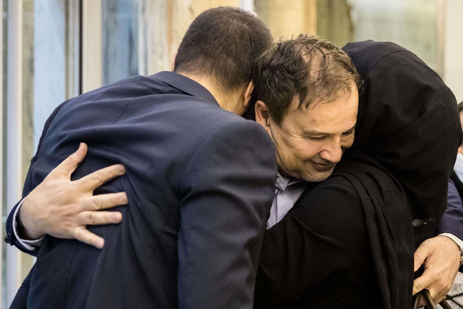 Majid Taheri hugs his children upon his arrival at Tehran's Imam Khomeini International Airport