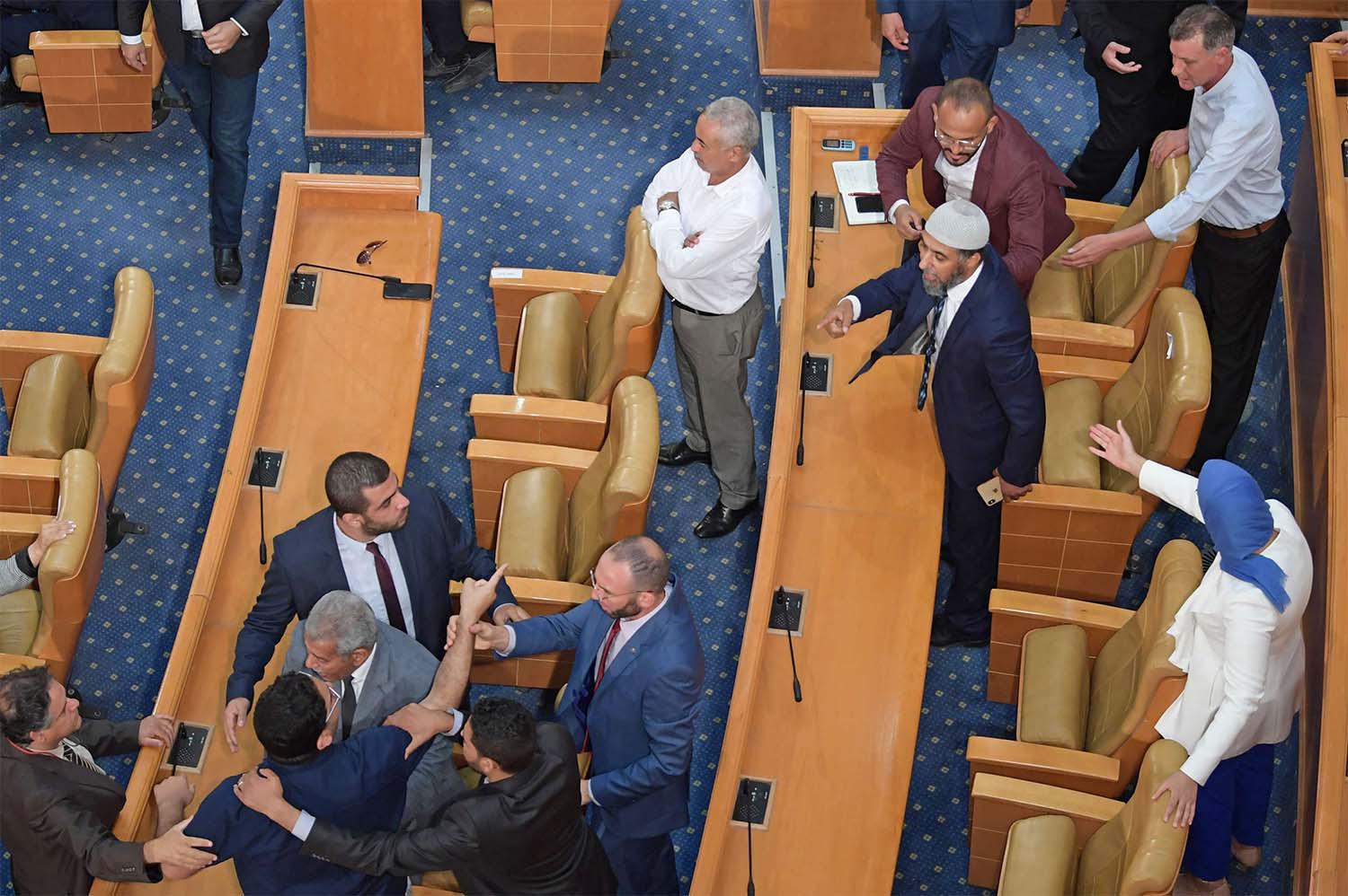 Tunisian MPs argue during a plenary session devoted to discussing a motion tabled by the Free Destourian Party