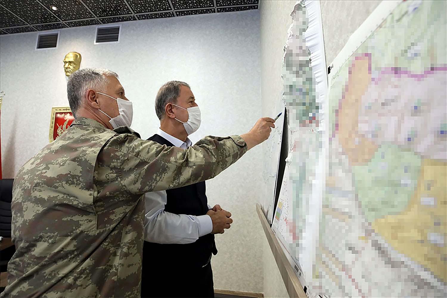 Turkish Minister of Defence Hulusi Akar (R) 