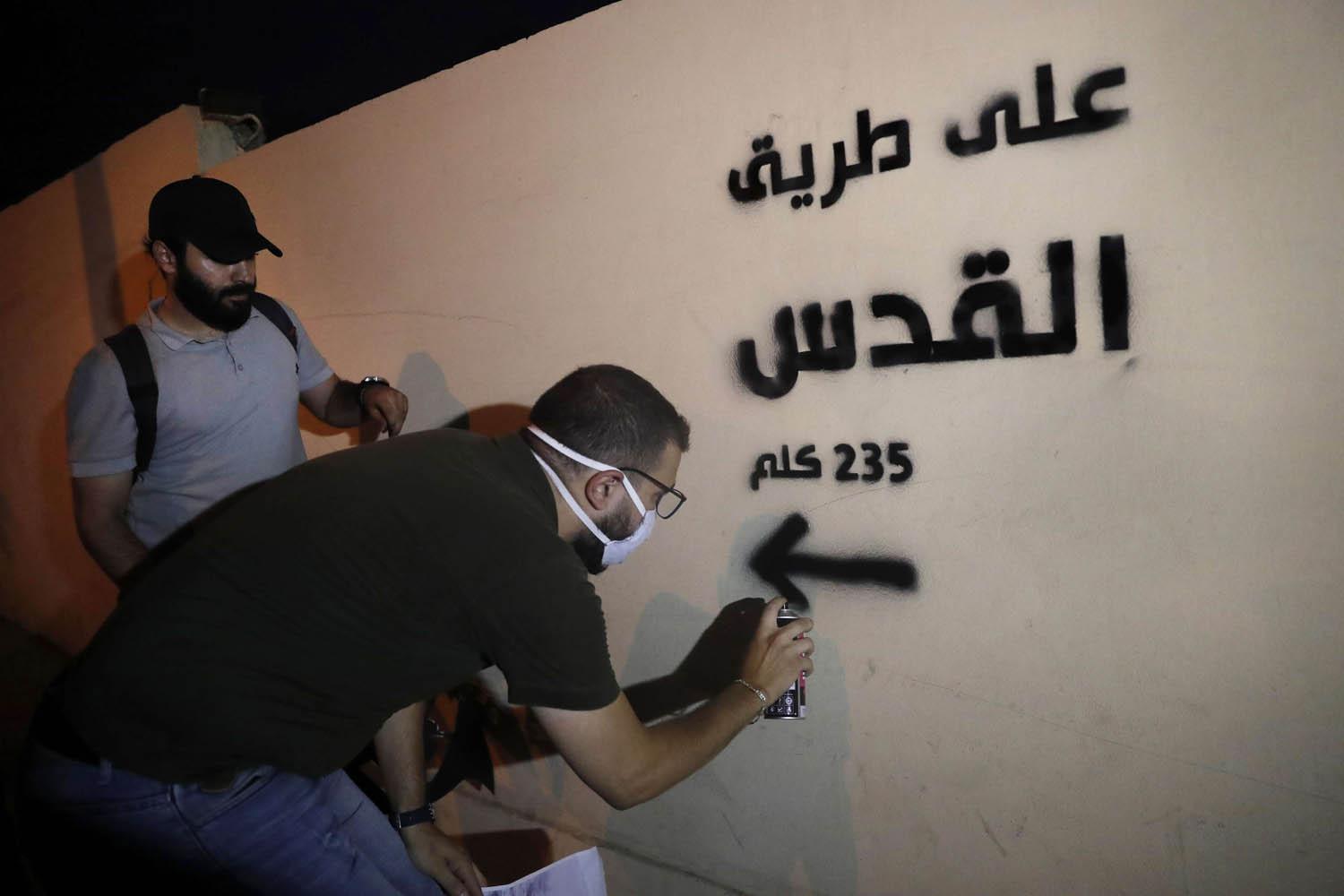 ناشطون من حزب الله يخطون على جدران في بيروت في اشارة للقدس