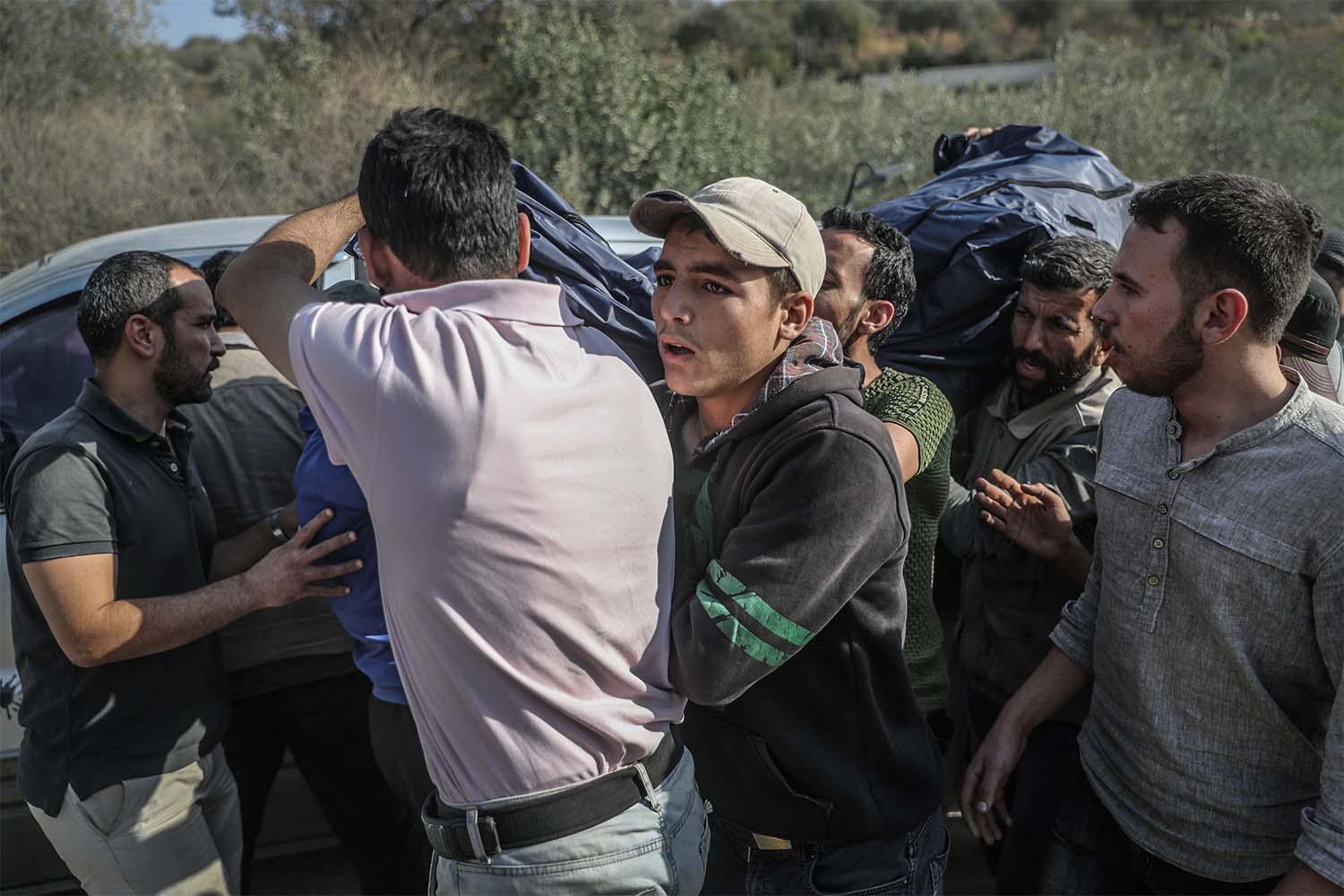 Syrians carry the coffin of one of the fighters of the Turkish-backed Faylaq al-Sham rebels grou