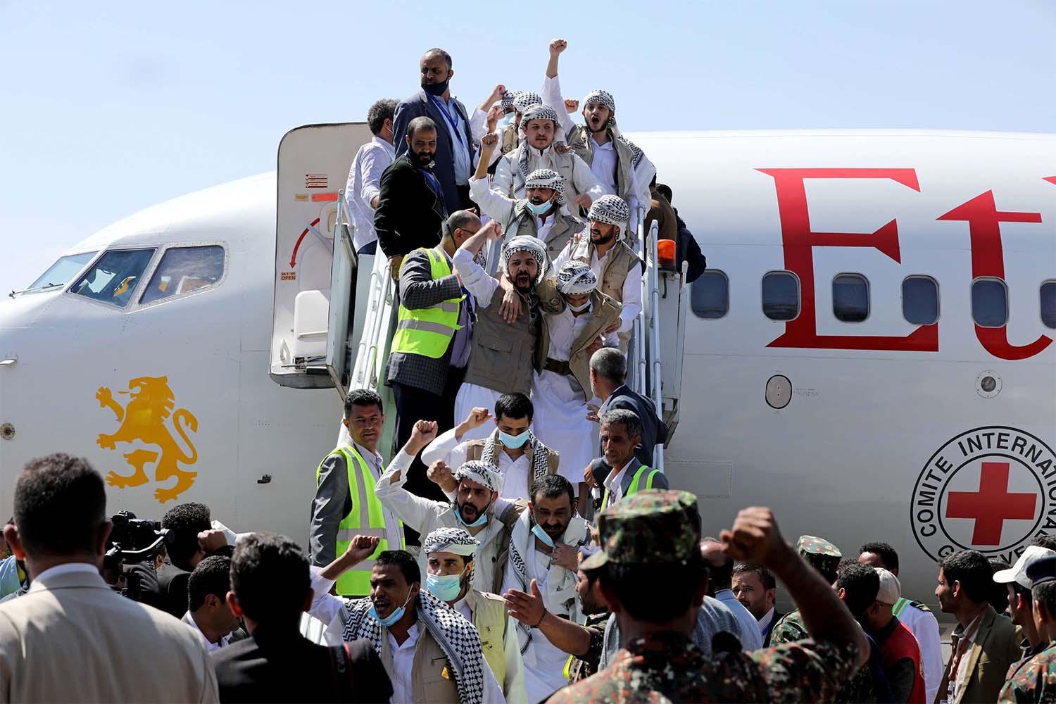 Freed Huthi prisoners arrive after their release in a prisoner swap, in Sanaa airport
