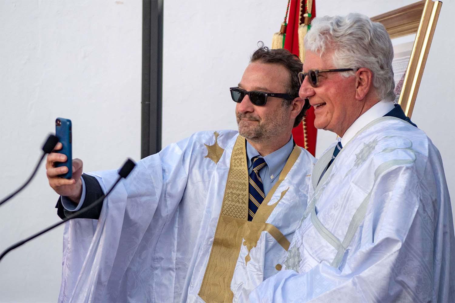 US ambassador to Morocco David Fischer (R) and US Assistant Secretary of State David Schenker take a selfie wearing a traditional Sahrawi dress 