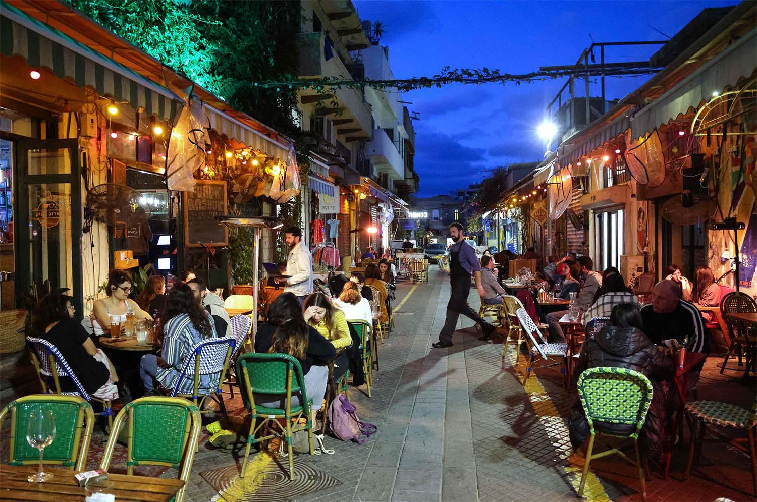 People eat at a restaurant in the Israeli coastal city of Tel Aviv