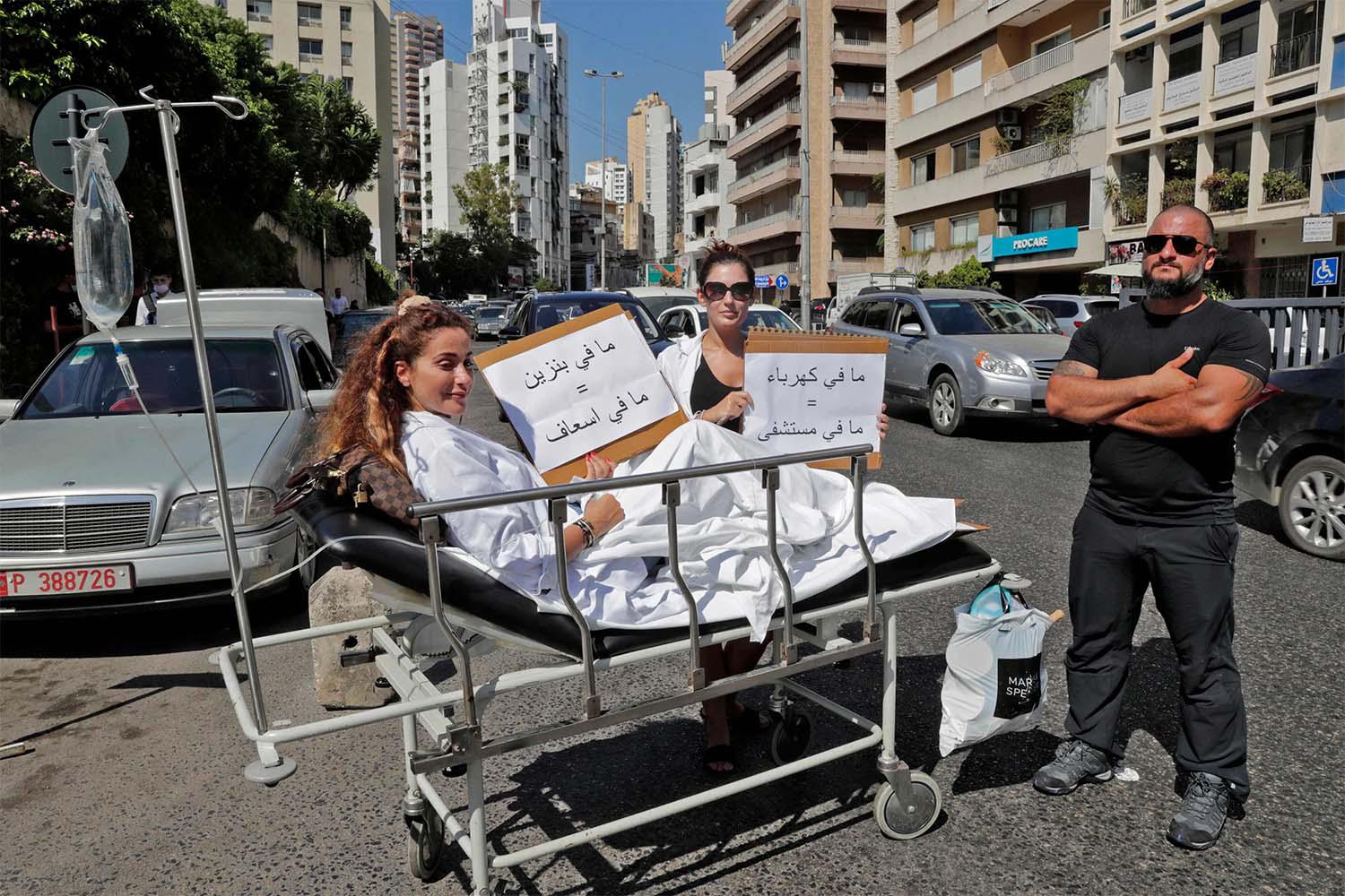 "no gasoline = no ambulance," reads the sign