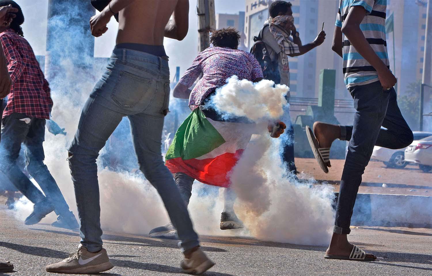 Braving tear gas to protest against military rule
