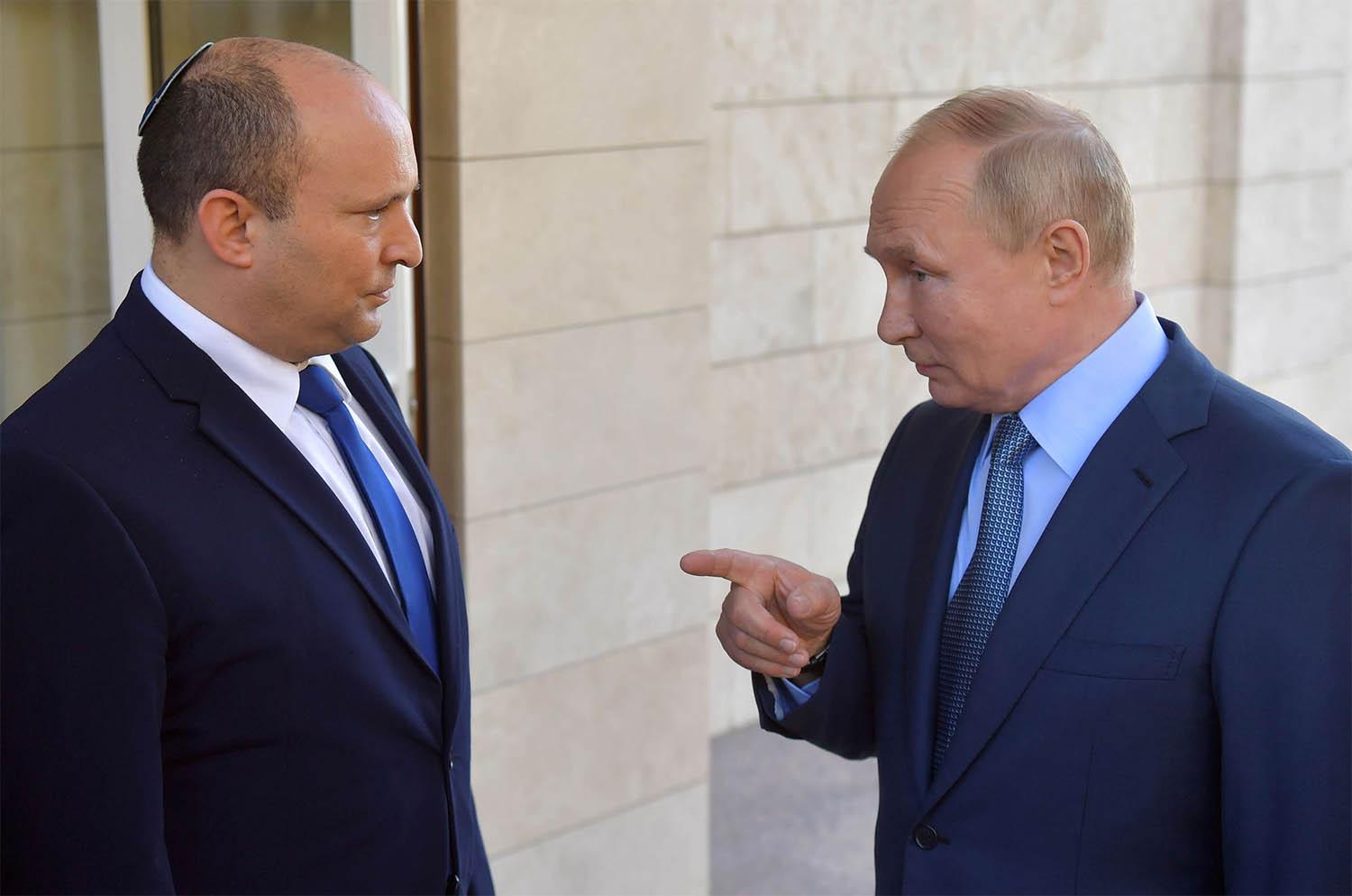 Russian President Vladimir Putin talks to Israeli Prime Minister Naftali Bennett 