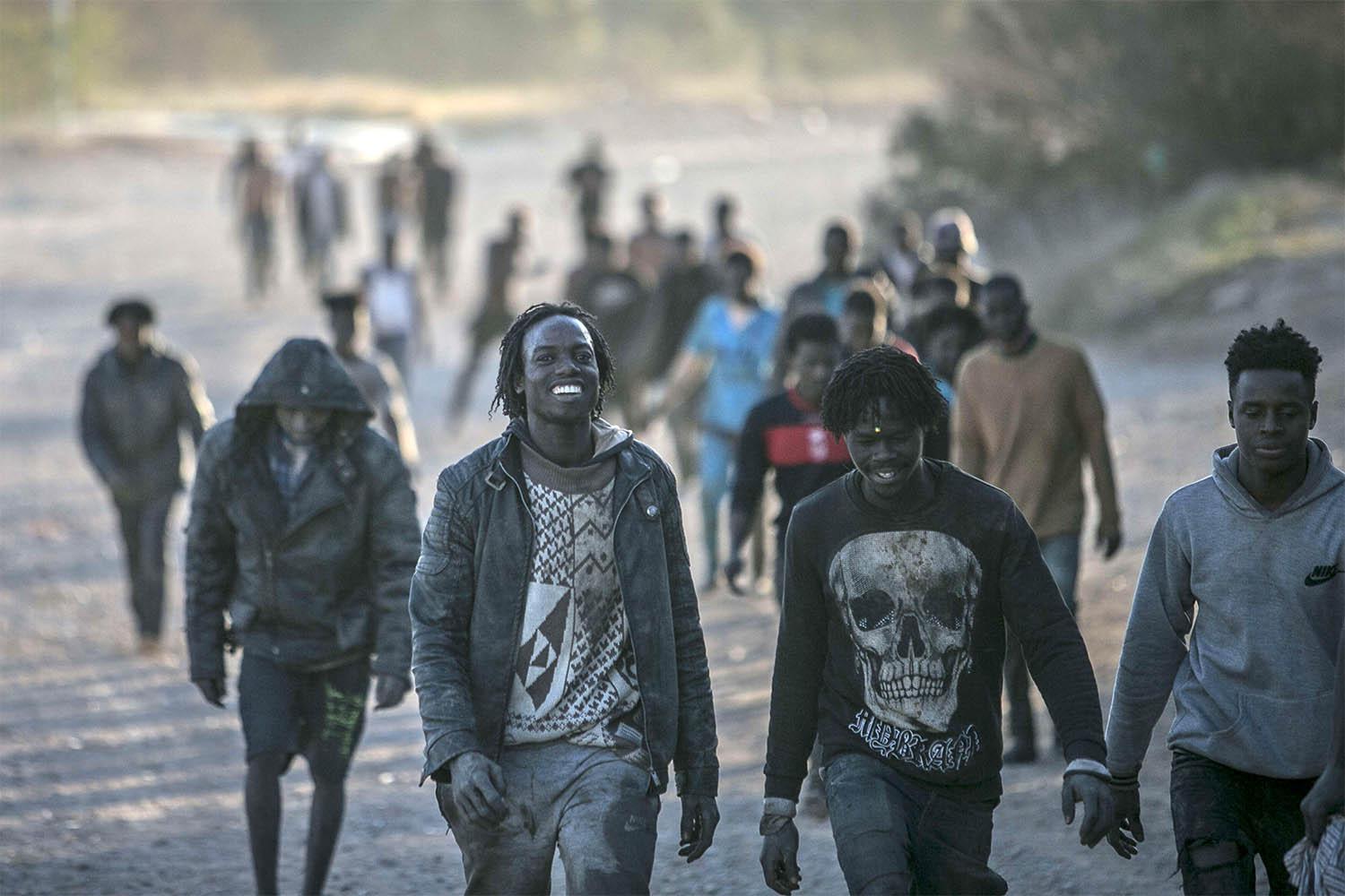 Migrants arrive on Spanish soil after crossing the fences