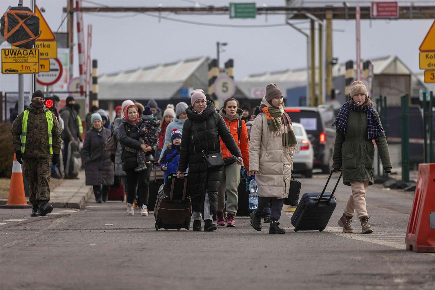 Refugees from Ukraine are pictured after crossing the Ukrainian-Polish border