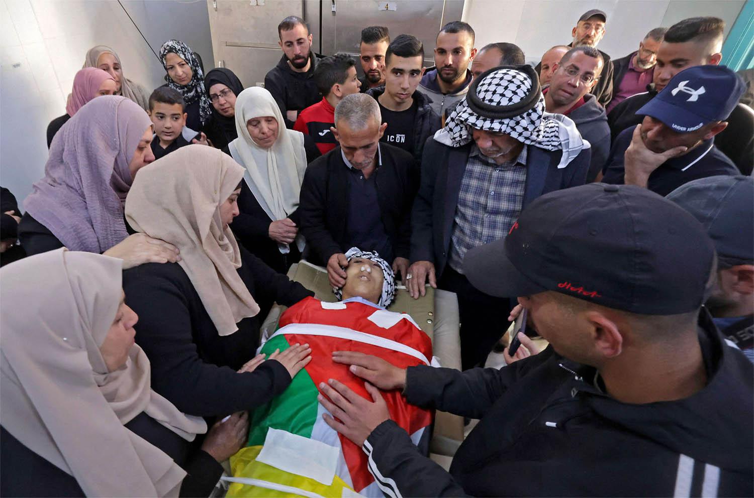Parents of 16-year-old Palestinian Qusai Hamamrah mourn over his body during his funeral in the village of Husan, north of Bethlehem 