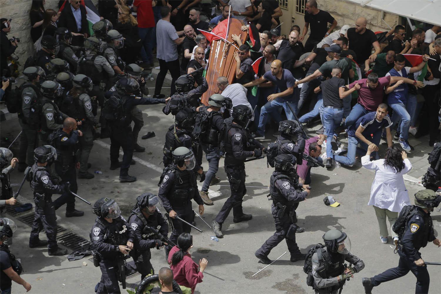 Israeli police beat mourners as they carried the casket of slain Shireen Abu Akleh during her funeral in east Jerusalem