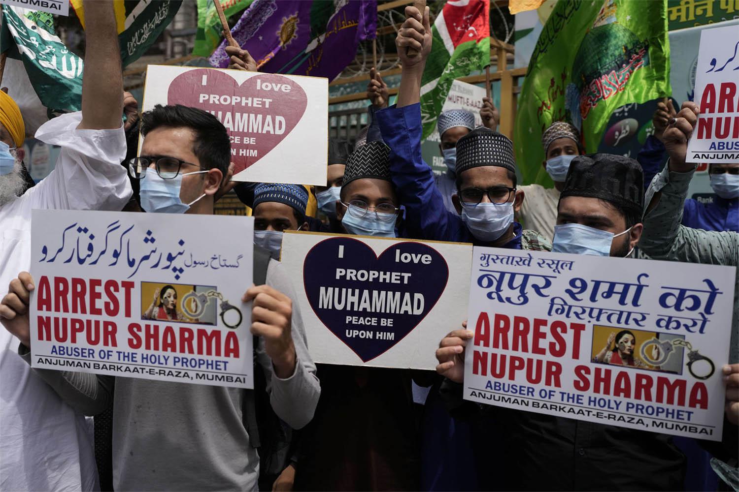 Indian Muslims hold placards demanding the arrest of Nupur Sharma