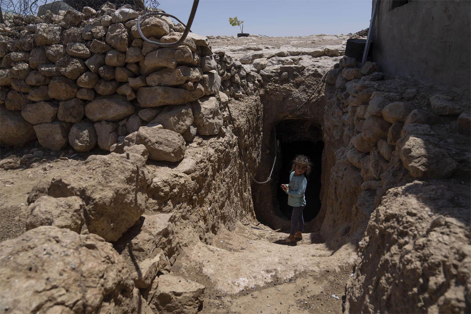 The entrance to Abu Sabaha's cave is surrounded by the ruins of homes and animal pens that the soldiers demolished in earlier raids