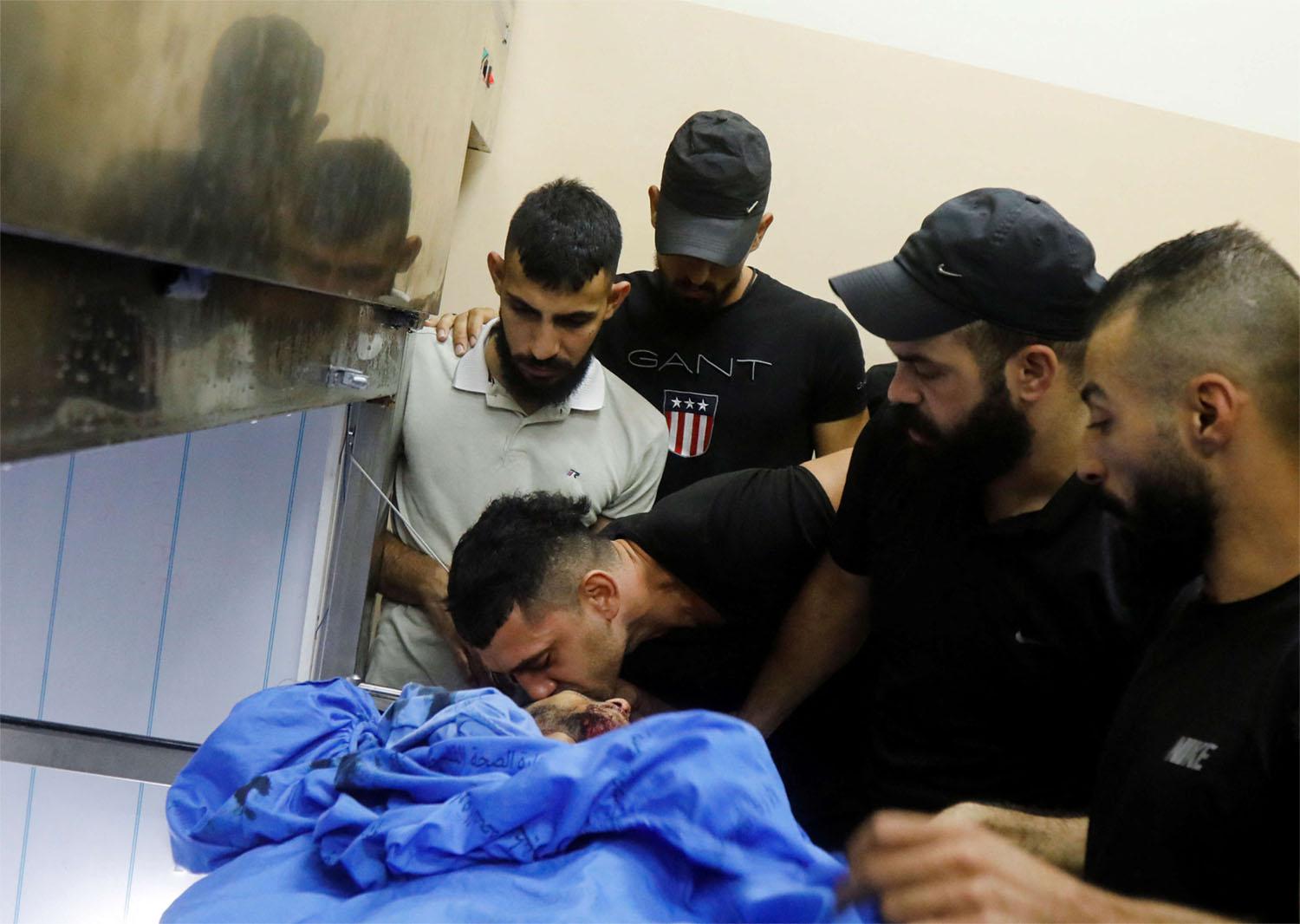 People react after Israeli forces killed Palestinian Younes Tayeh