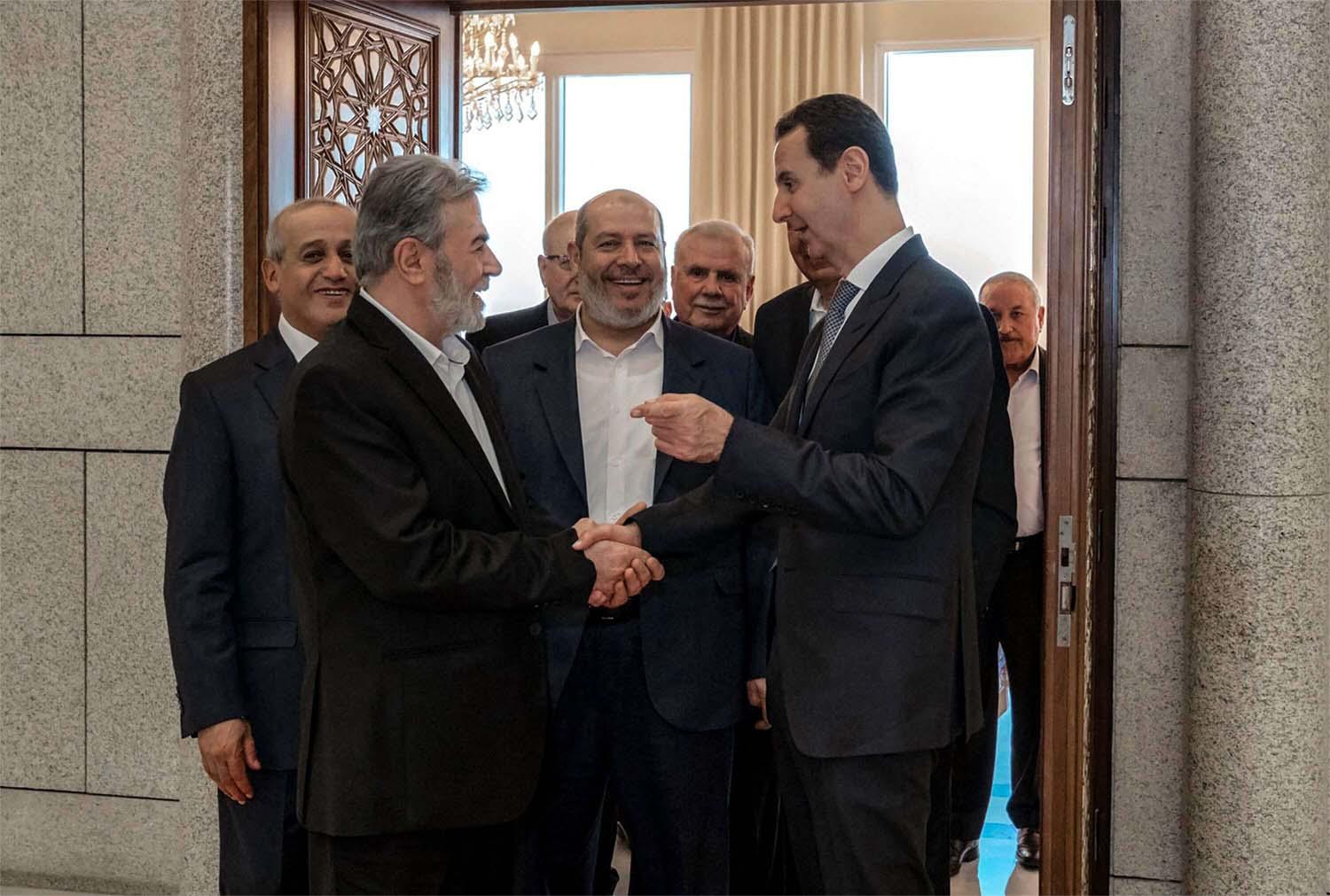 Syia's President Bashar al-Assad (R) receiving Hamas chief of Arab relations, Khalil al-Hayya