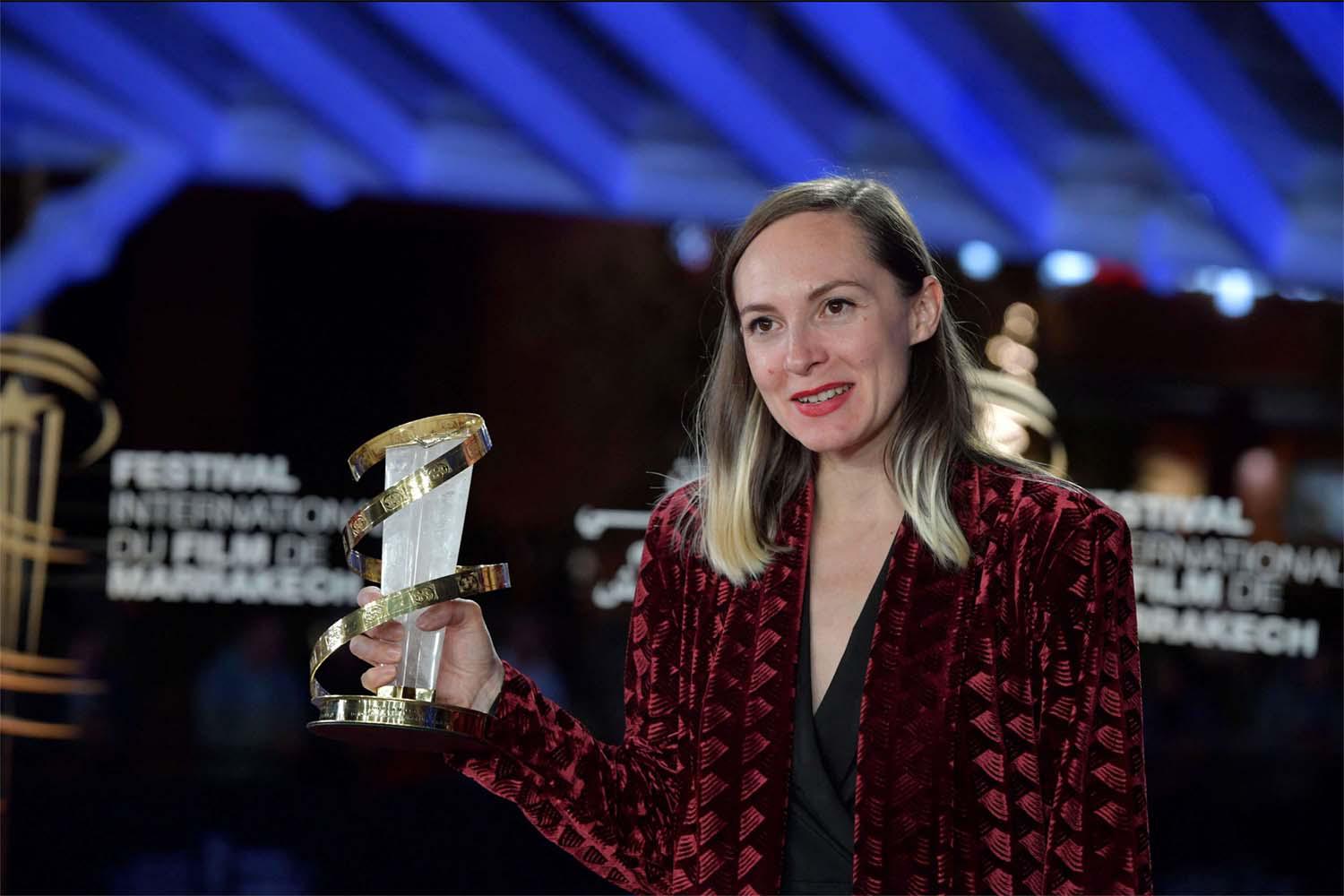 Swiss director and screenwriter Carmen Jaquier poses with her Best Direction Award award