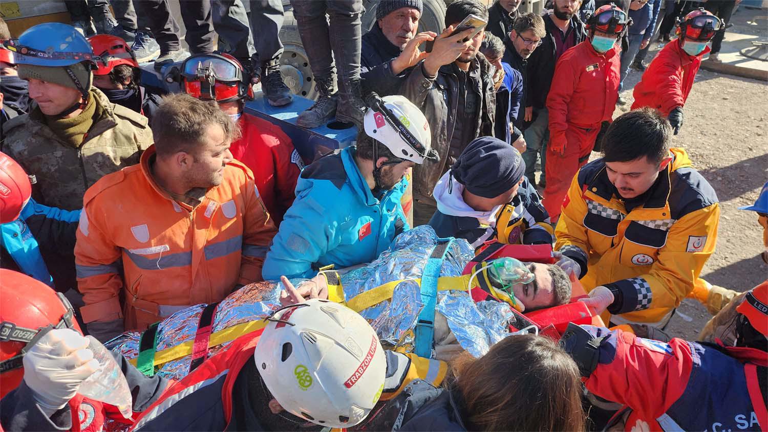 Rescue workers carrying Cafer strapped on a stretcher