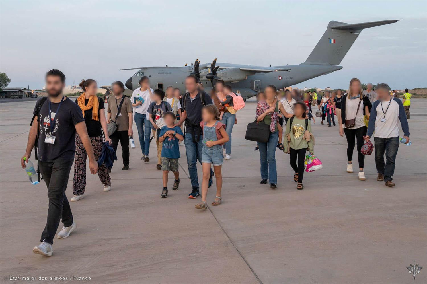 French citizens arrive at the air base of the French Army forces stationed in Djibouti after being evacuated from Sudan 