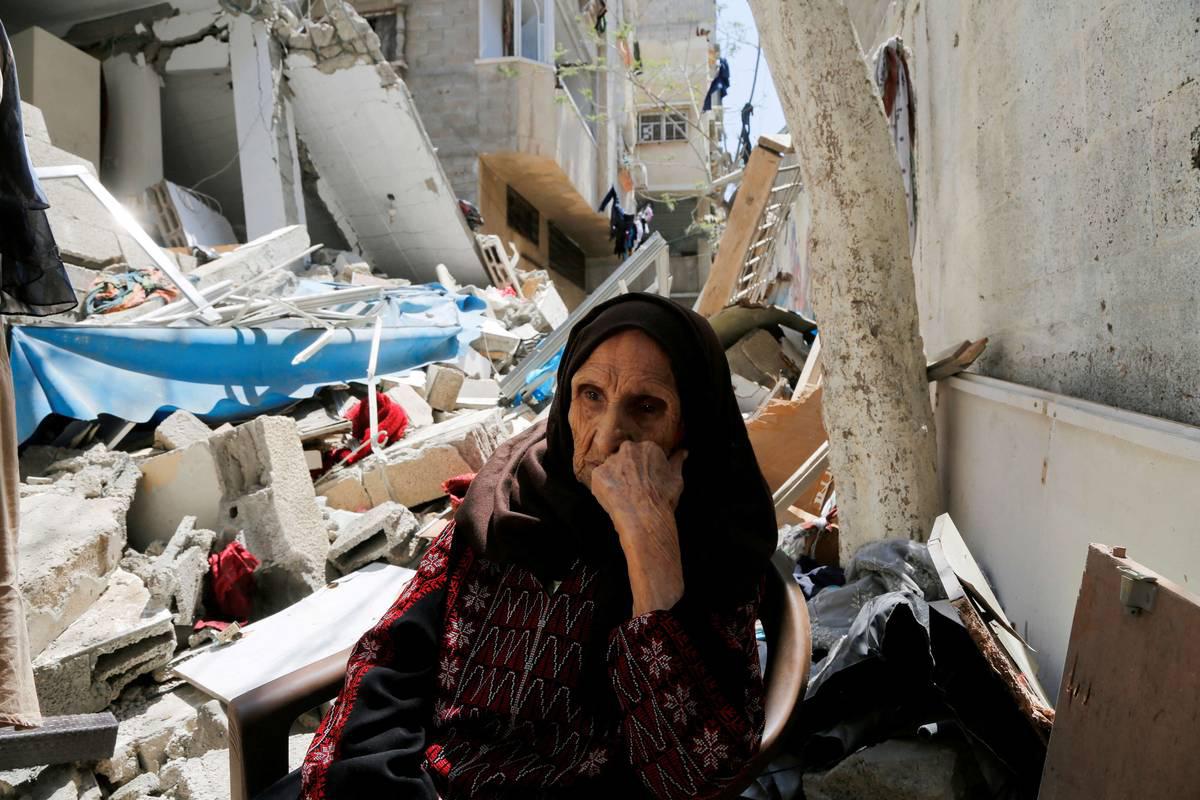 مسنة فلسطينية (97 سنة) مهجرة من عام 48 تجلس على اطلال بيتها المهدم في القصف الإسرائيلي الأخير في غزة