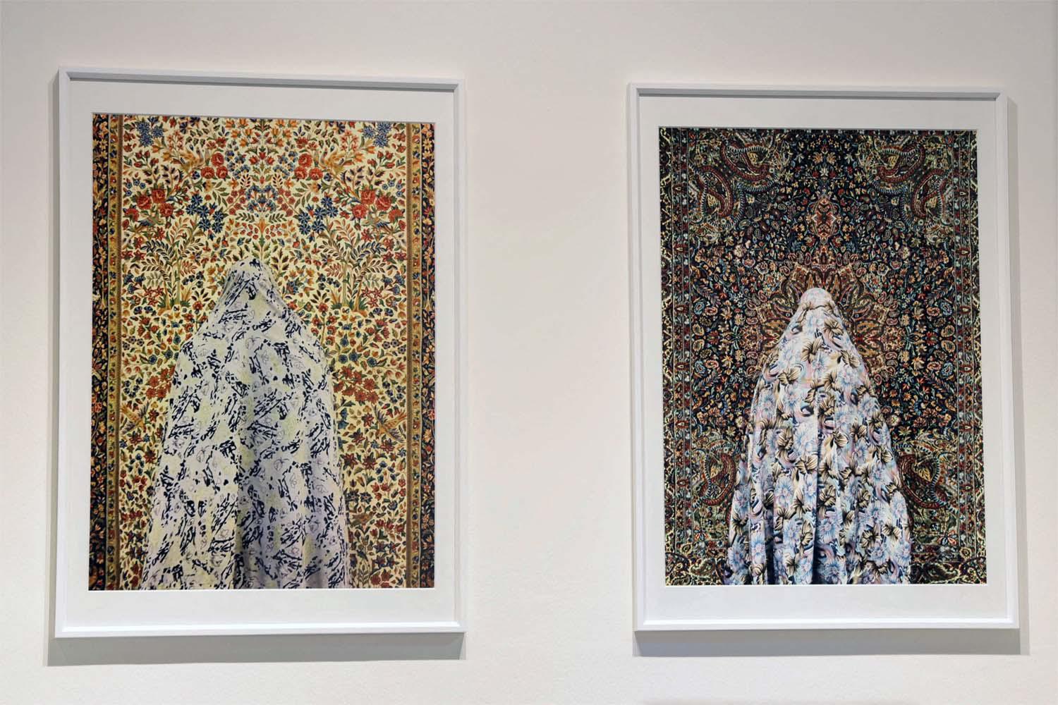 The women are photographed from behind and the pattern of their chador