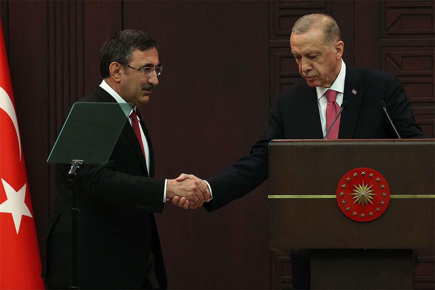 Turkey's new vice president Cevdet Yilmaz (L)