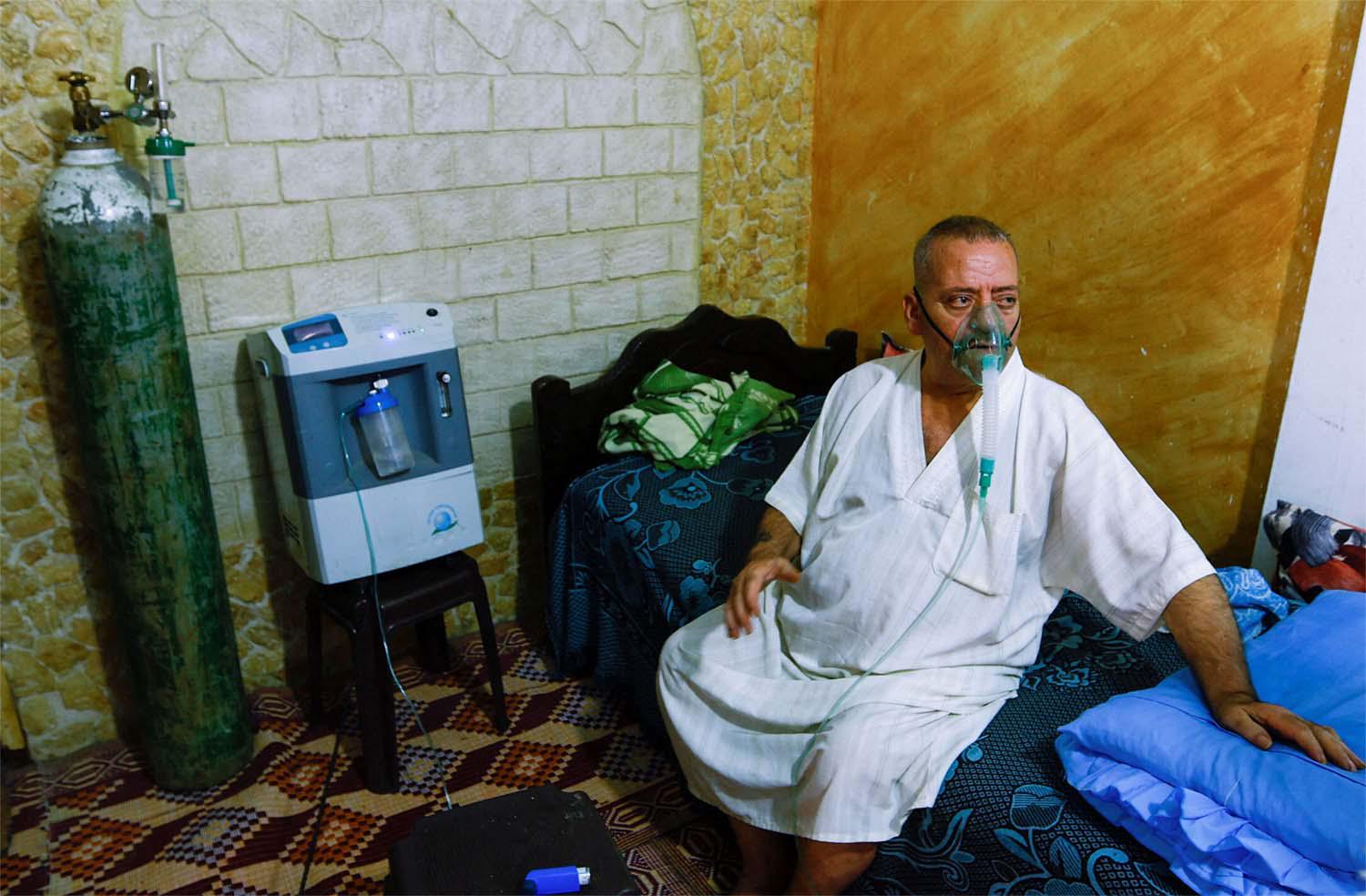 Ismail Nashwan struggles for breath at his house amid a heatwave in Al Burij refugee camp