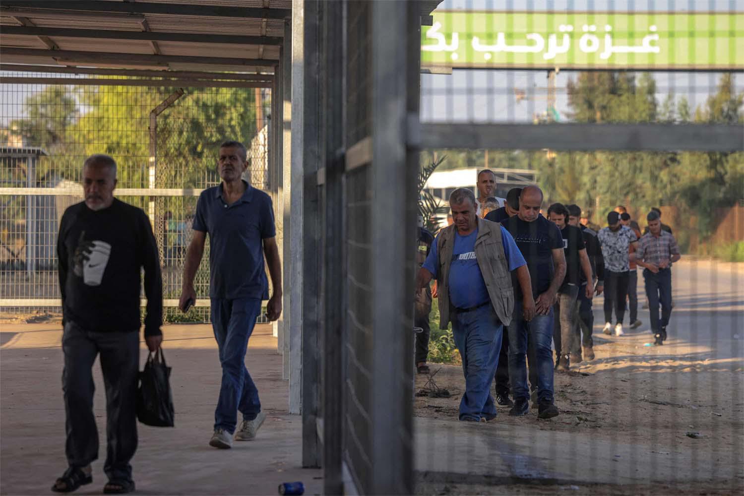 Palestinian workers gather at the Erez crossing between Israel and the northern Gaza Strip