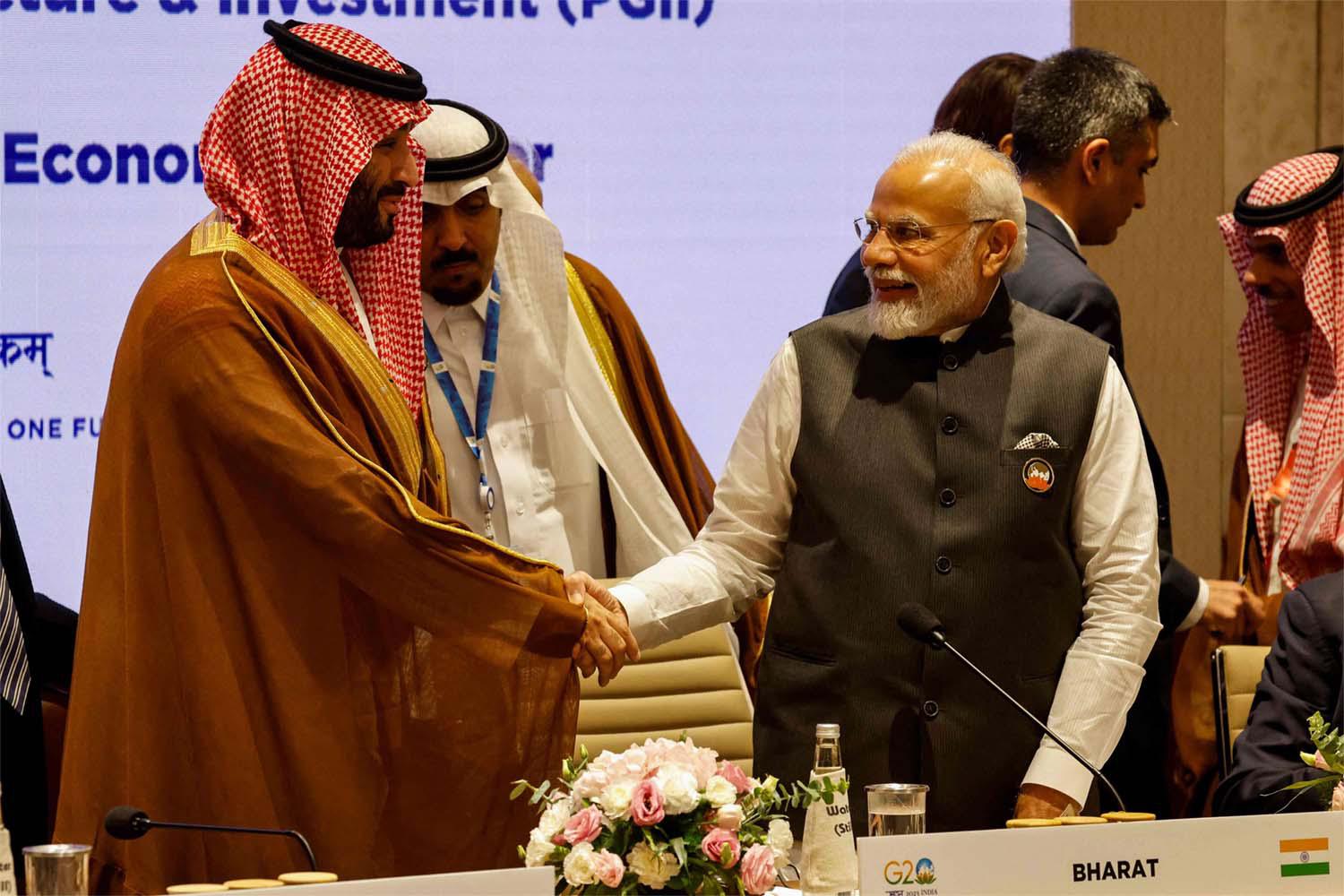 India's Prime Minister Narendra Modi and Saudi Arabia's Crown Prince Mohammed bin Salman shake hands during a session of the G20 Leaders Summit
