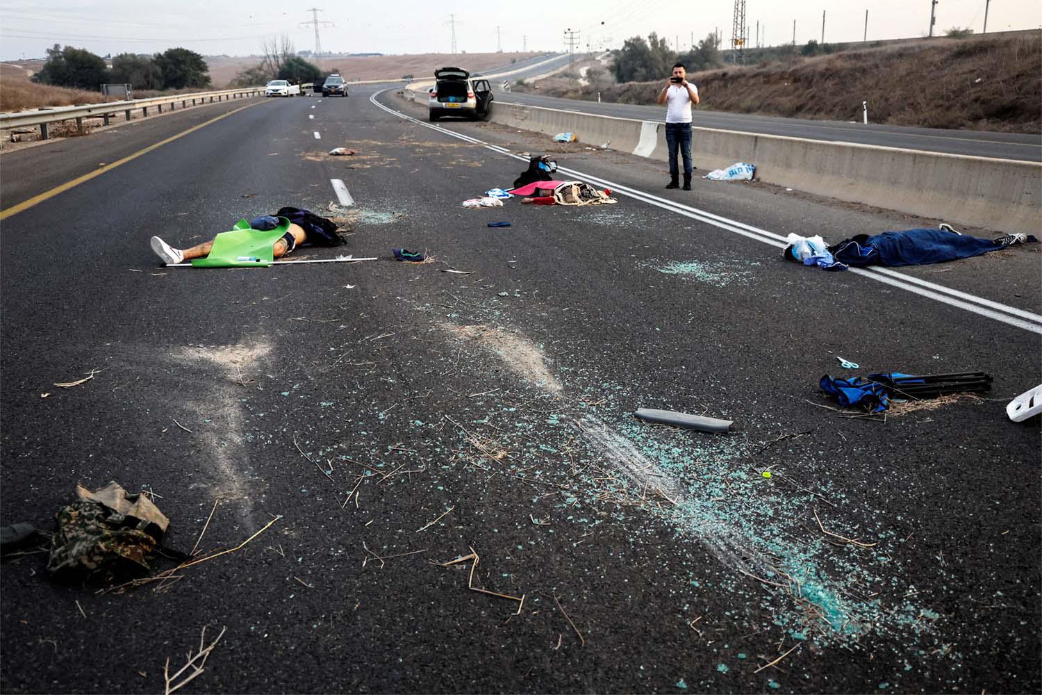 Dead people strewn across a road following a mass-infiltration by Hamas gunmen in the Sderot area