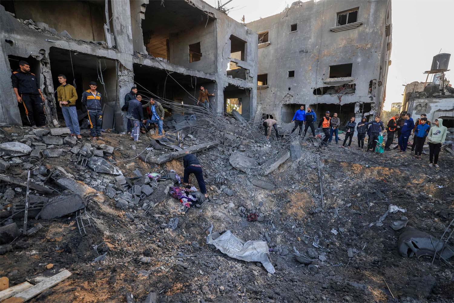 Rescuers look for survivors in the rubble of the al-Agha family home following an Israeli strike in Khan Younis on the southern Gaza Strip