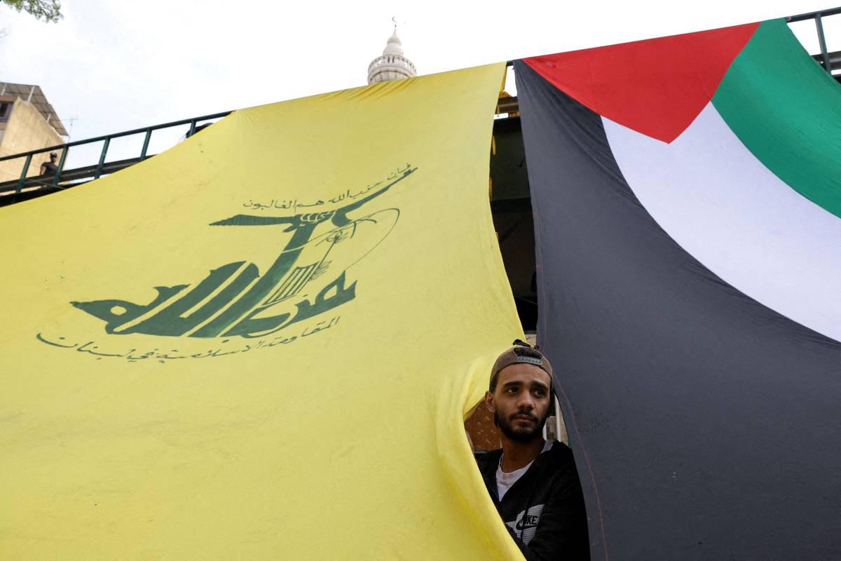 ناشط من حزب الله ينظر على تشييع مقاتل للحزب