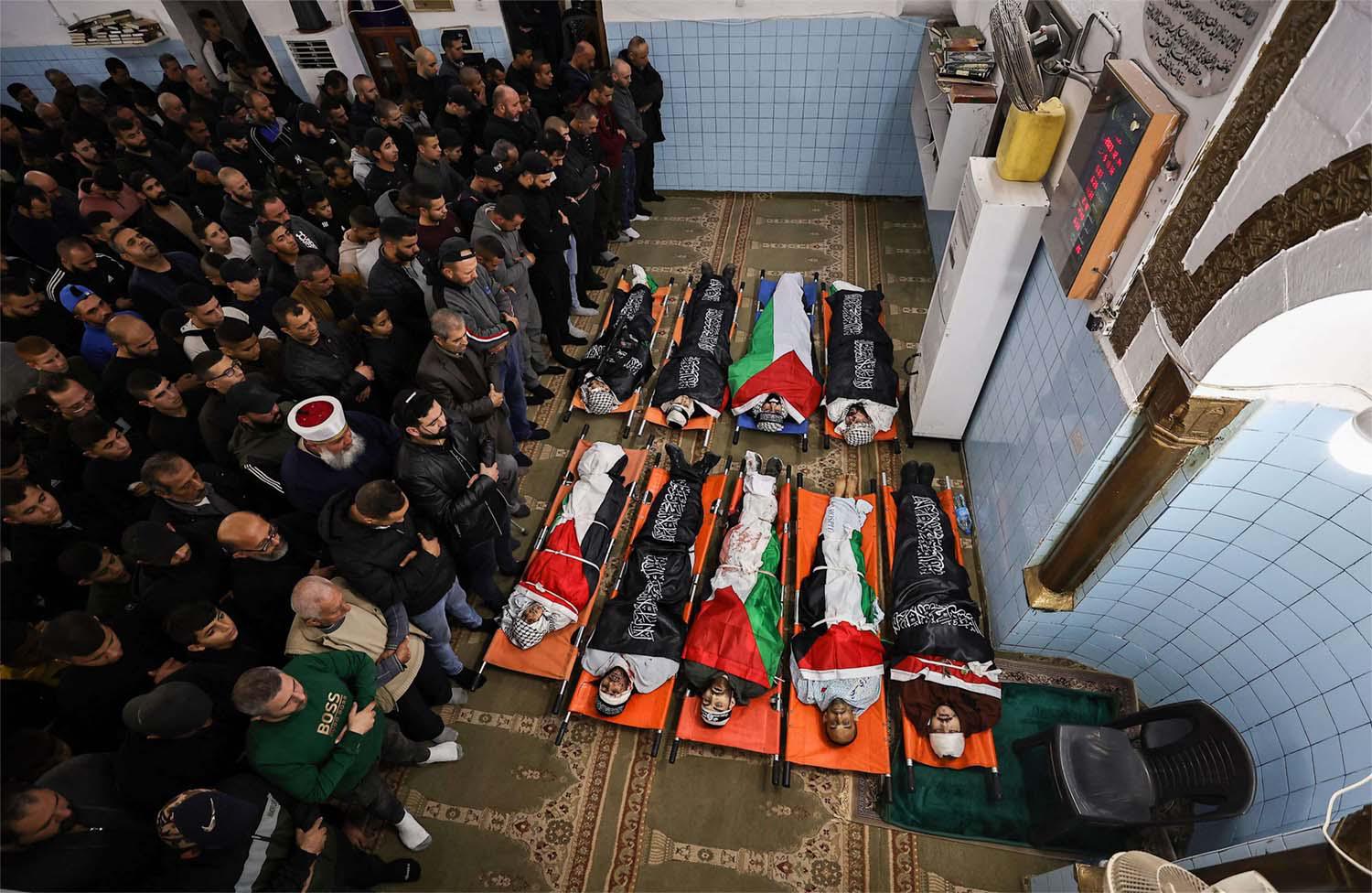 Relatives and friends pray over the bodies of Palestinians killed during a three-day incursion by the Israeli army on the Jenin camp