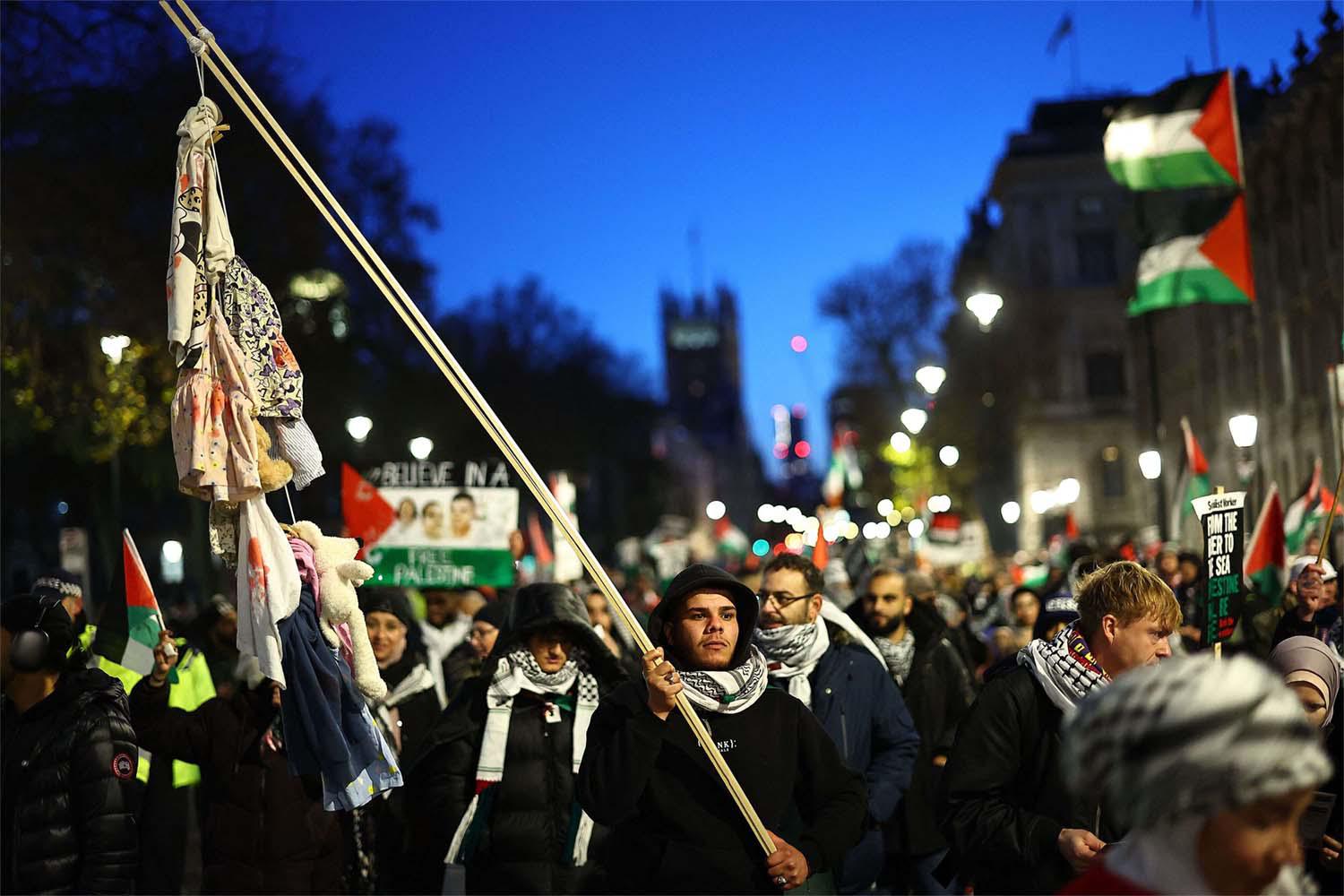 Thousands of people have worn keffiyehs in huge protests in Britain 