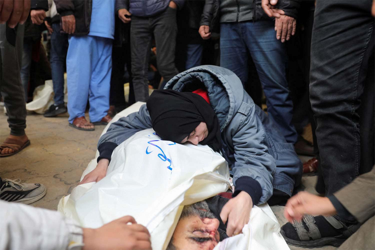 A mourner embraces the body of a Palestinian killed in an Israeli strike on Khan Younis