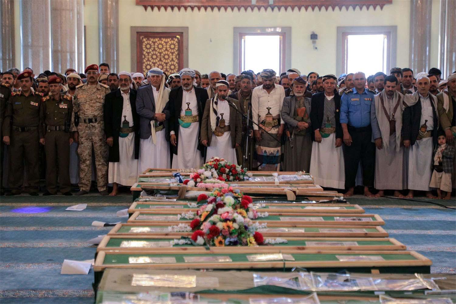 Mourners gather to pray near the coffins of Houthi rebels who were killed in recent US-led strikes, in Sanaa's Al-Saleh mosque