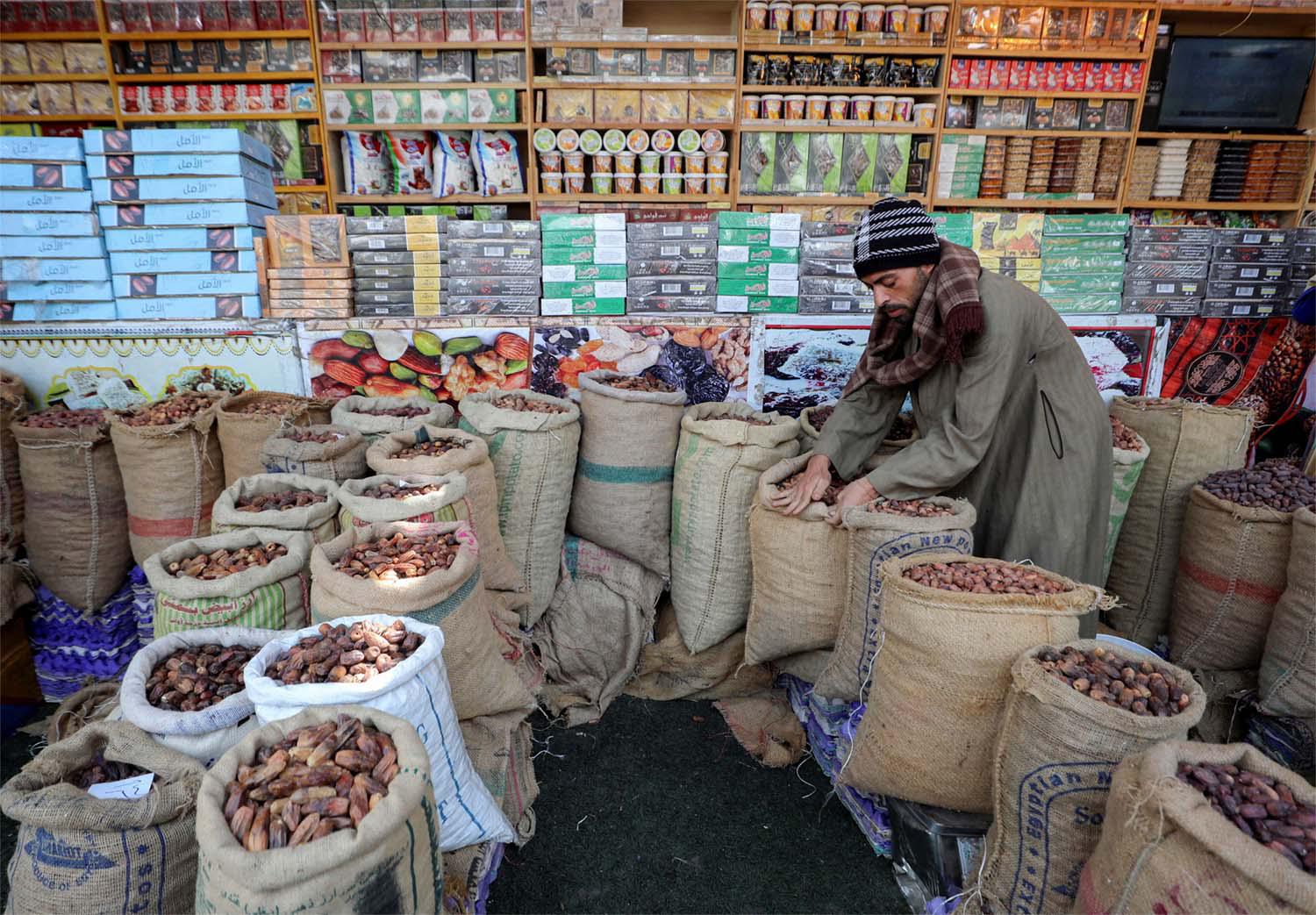 An Egyptian seller waits for customers at his dates shop ahead of the Muslim fasting month of Ramadan