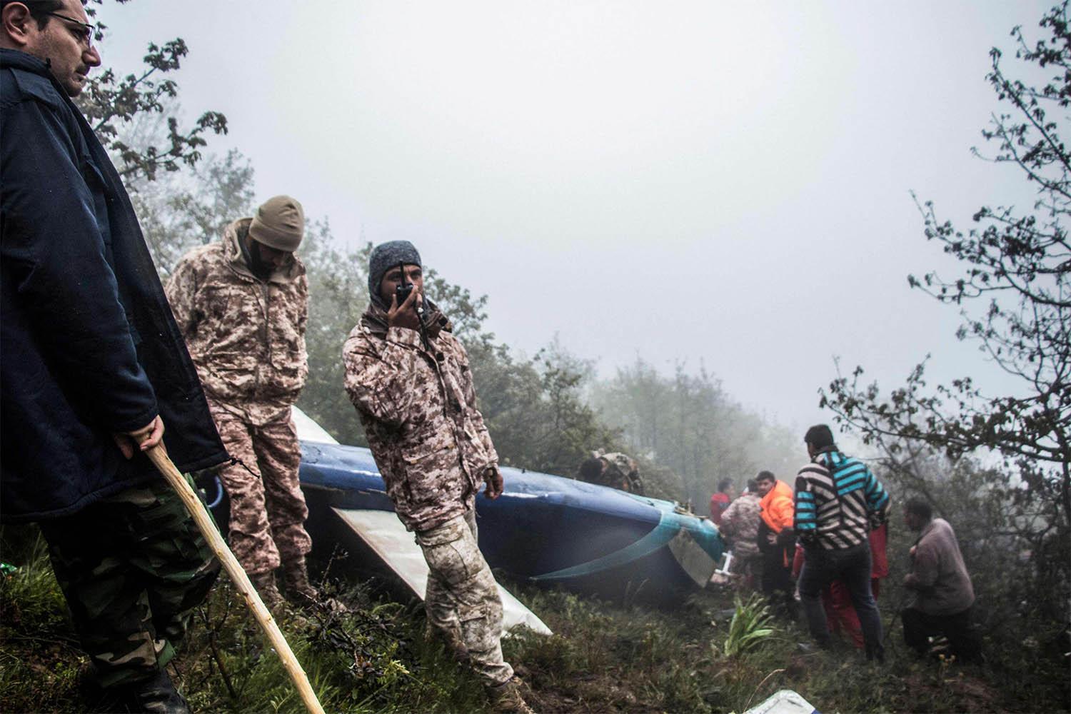 Rescue team members at the crash site of a helicopter carrying Iranian President Raisi in Varzaghan