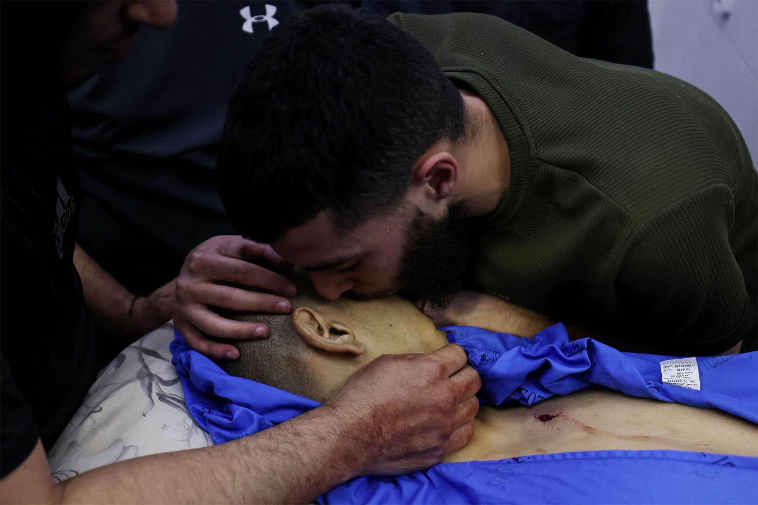 A Palestinian man bids farewell to a relative killed in an Israeli army raid on Jenin at the mortuary 