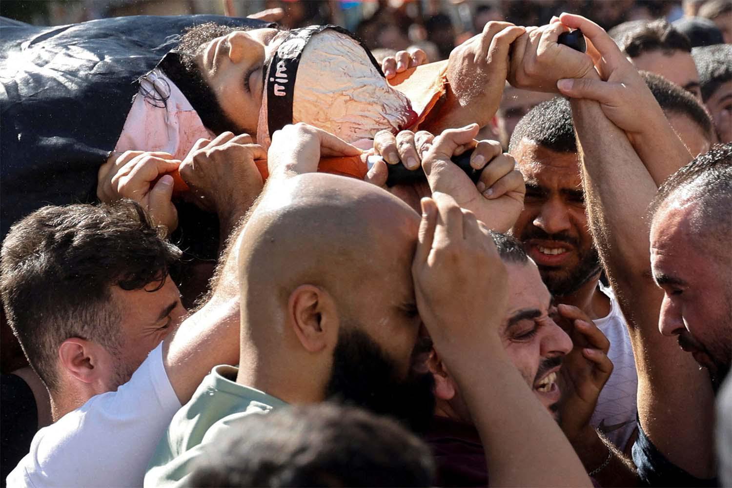 ourners carry the body of Palestinian militant, Nidal al-Amer who was killed by Israeli forces in Jenin