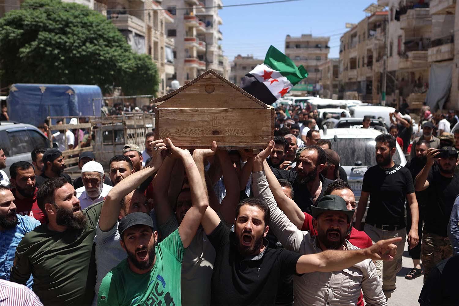 Syrians attend the funeral procession of a man killed during clashes with Turkish troops in Afrin in northern Syria