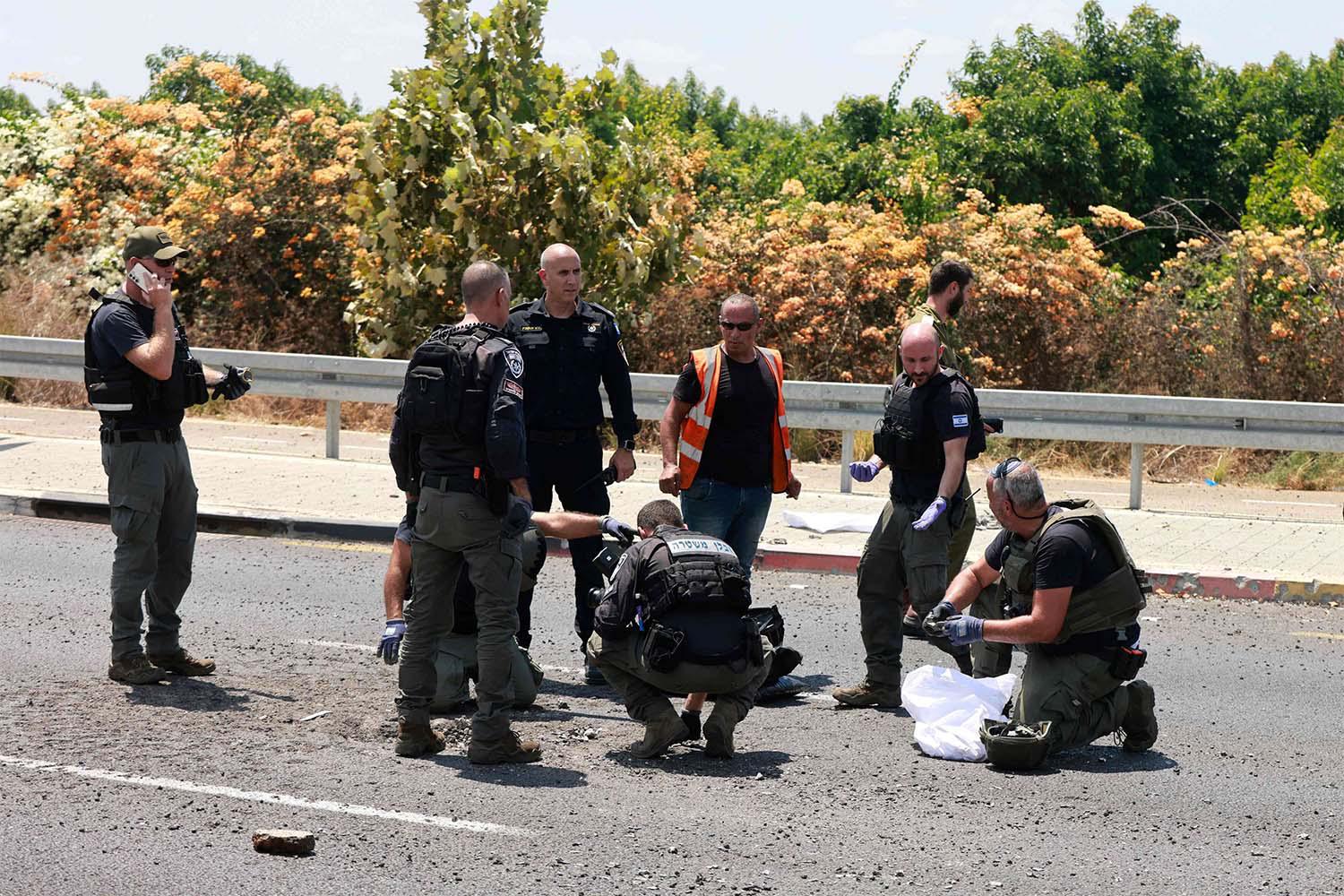 Israeli police check the site of a Hezbollah explosive drone attack near the northern city of Nahariya