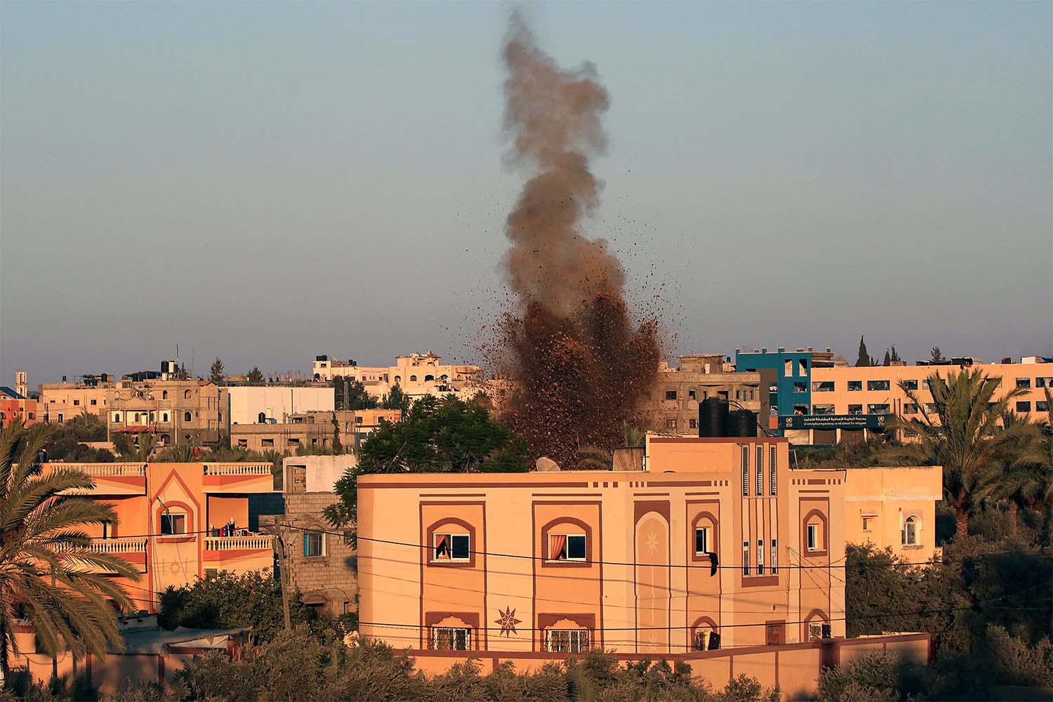 Smoke and soil billow after an Israeli strike in al-Zawayda in the central Gaza Strip 