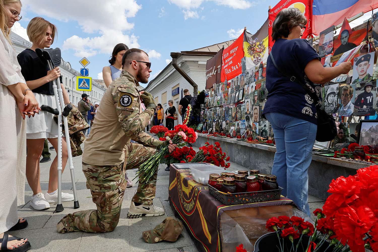 People gather in front of a makeshift memorial, which was erected following head of Russias Wagner mercenary group Yevgeny Prigozhin and group commander Dmitry Utkin's death in 2023