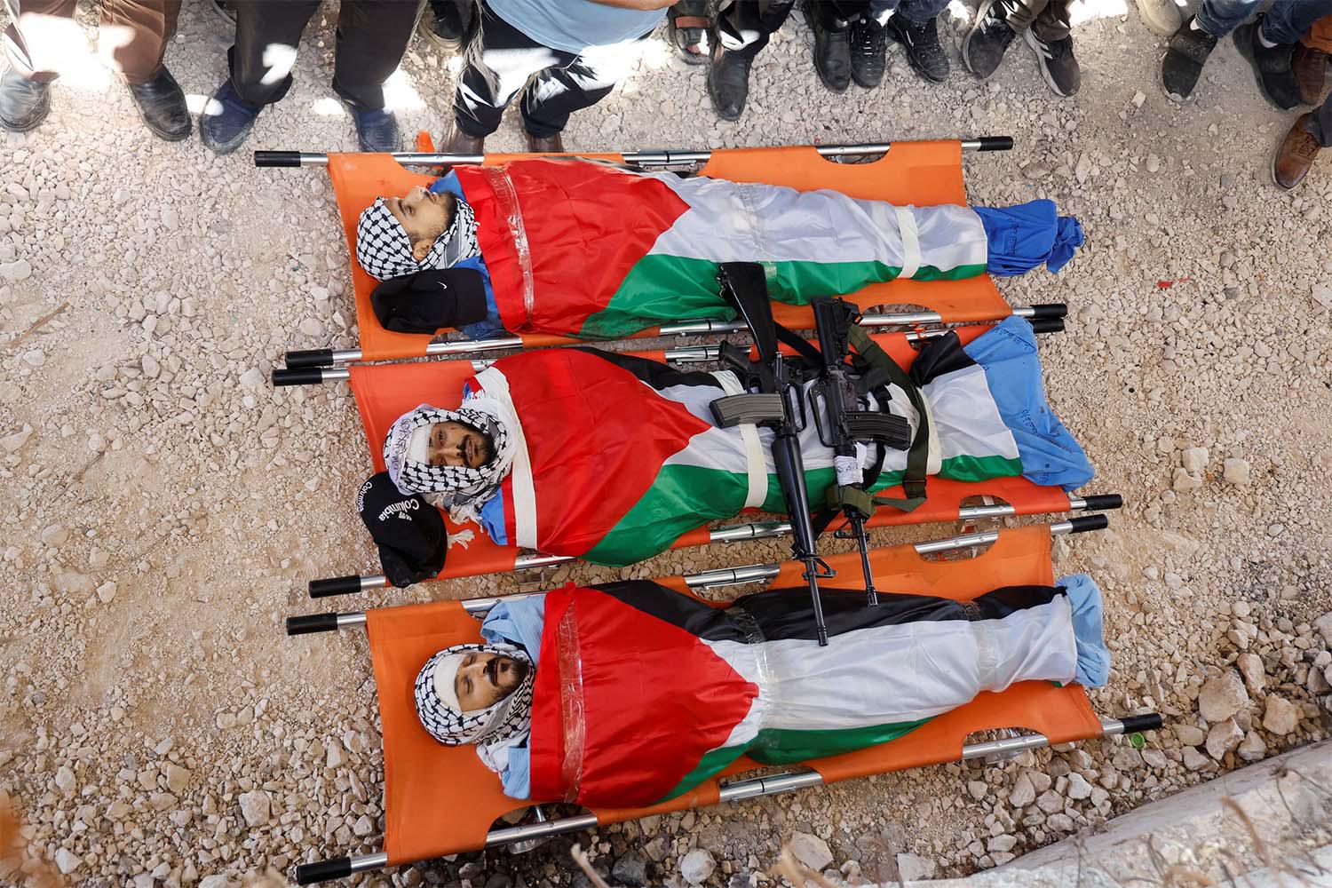 Bodies of three Palestinians who were killed in an Israeli raid