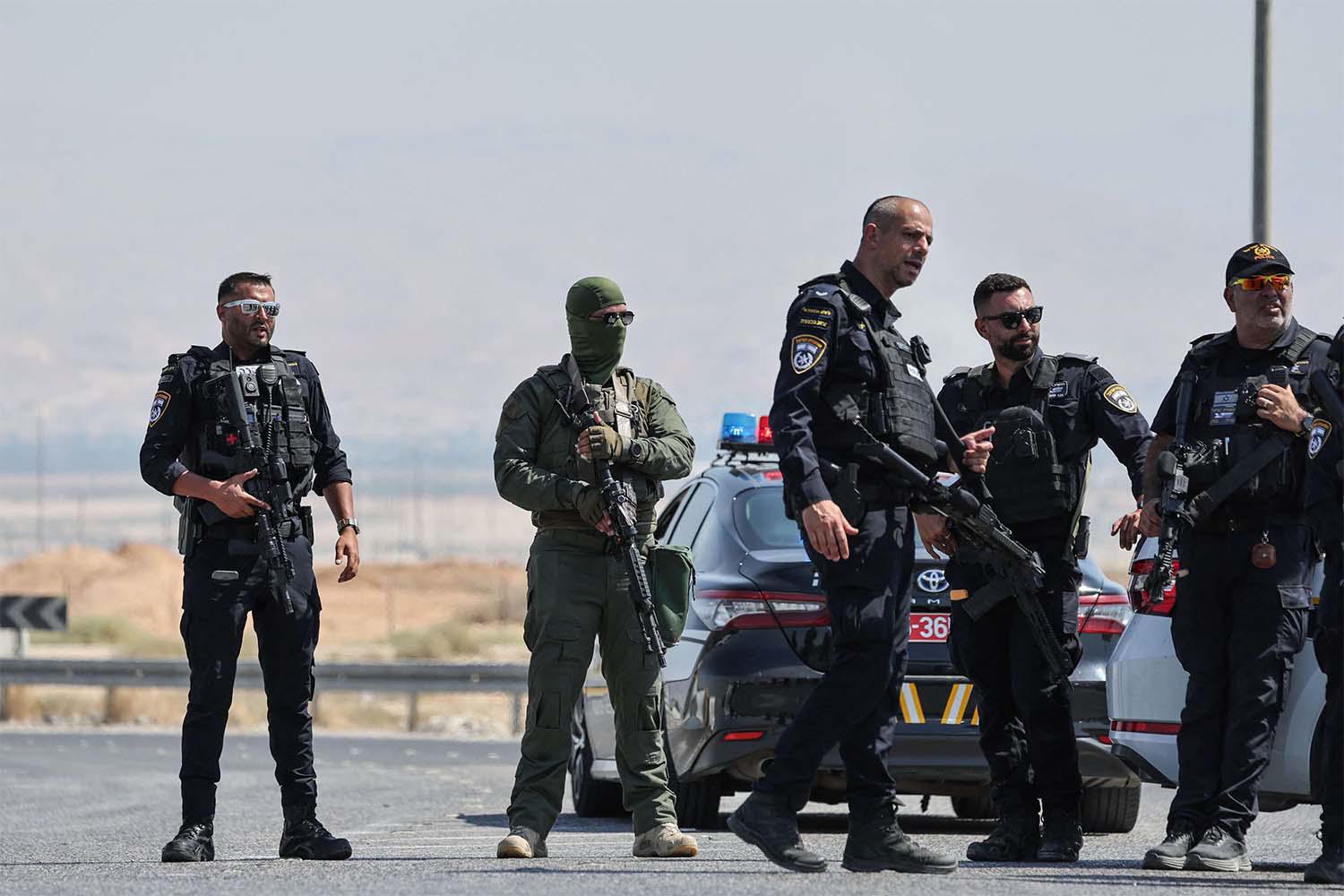 Israeli security forces gather at the scene of a reported attack near the Allenby Crossing