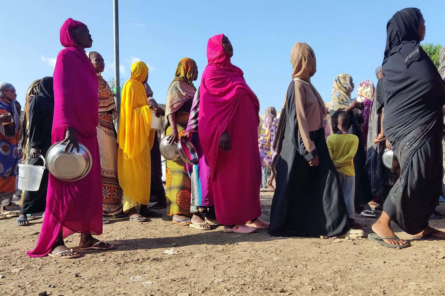 Displaced Sudanese queue for food aid at a camp in the eastern city of Gedaref