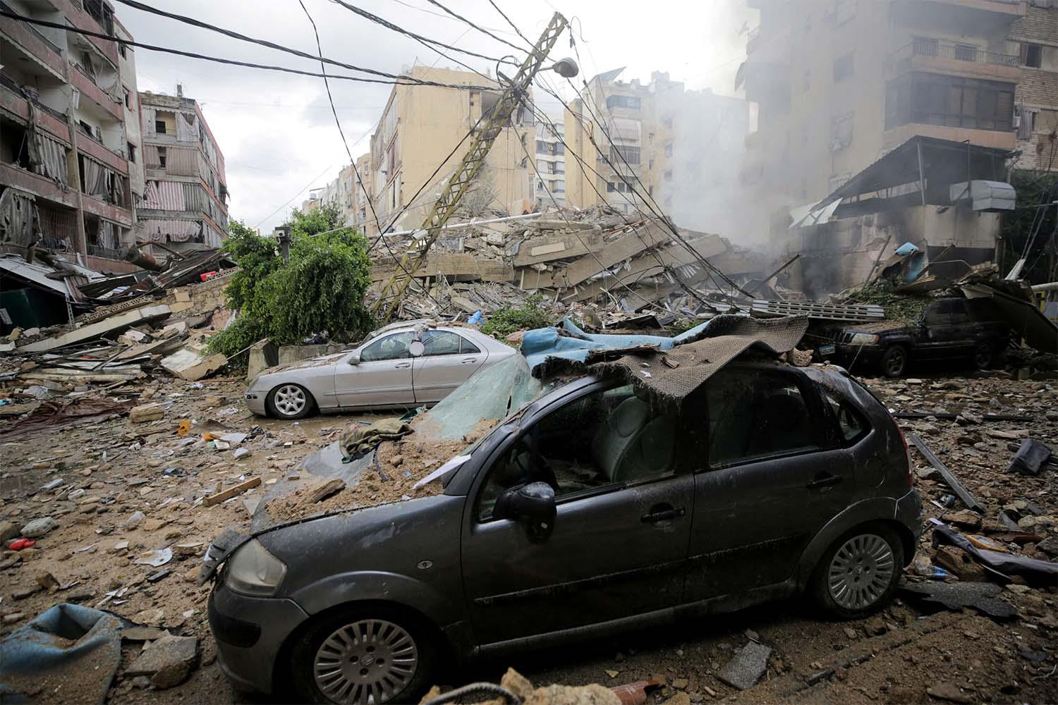 Damaged vehicles and buildings, in the aftermath of Israeli strikes on Beirut's southern suburbs