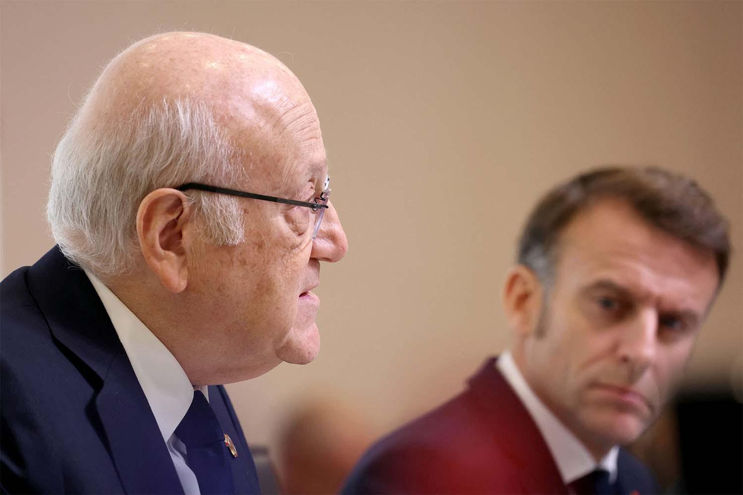 Lebanon's PM Najib Mikati (L) speaks next to Frances President Emmanuel Macron