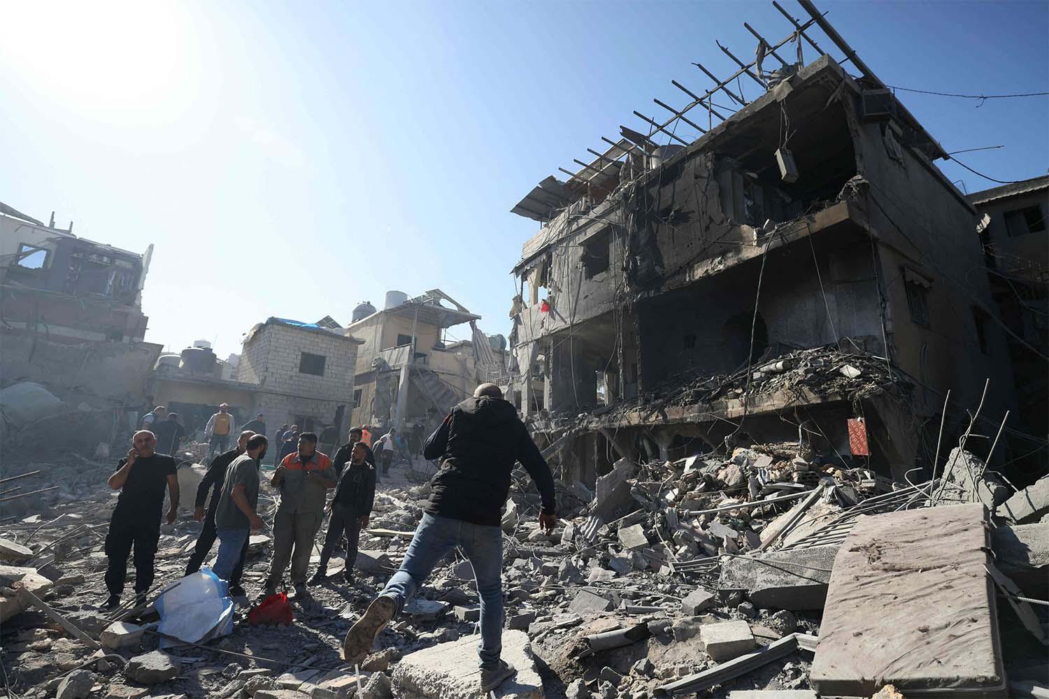 People inspect the debris a day after an Israeli airstrike in Beirut''s southern suburb of Jnah